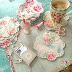 the table is covered with various items such as tea bags, headphones and ipods