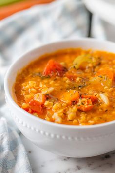 a white bowl filled with soup on top of a table