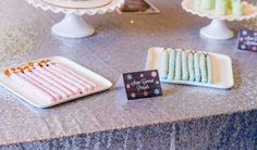 there are many desserts on the table with name tags in front of each one