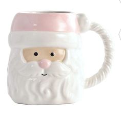 a ceramic mug with a santa clause on it's face and nose, sitting in front of a white background