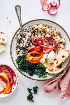 a bowl filled with vegetables and meat next to sliced radishes on a white surface