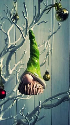 an ornament in the shape of a gnome's hat hanging from a tree