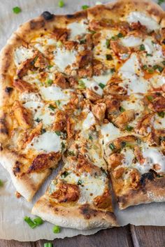 a pizza sitting on top of a wooden table