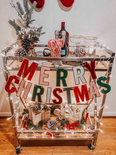 a merry christmas bar cart with lights and decorations