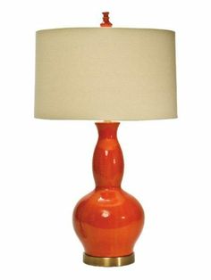 an orange table lamp with a white shade