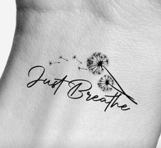 a dandelion tattoo with the words just breathe on it