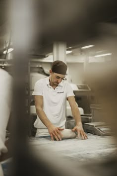 a man rolling dough on top of a counter