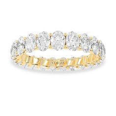 a yellow gold and white diamond ring with rows of round diamonds on the side, set in