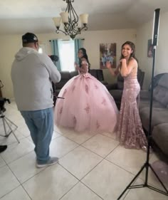 a woman in a pink dress standing next to a man