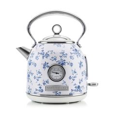 a white and blue flowered kettle with a clock on the front, side view