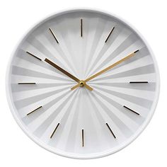 a white clock with gold hands on a white background