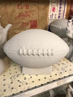 a white football sitting on top of a table next to vases and other items