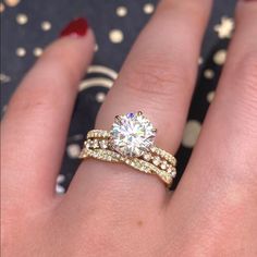 a woman's hand with a ring on it and a diamond in the middle