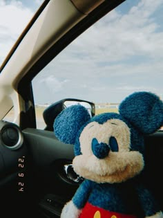 there is a stuffed mickey mouse in the car