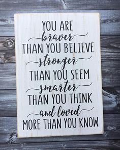 a wooden sign that says, you are braver than you believe stronger than you seem smaller than you think and loved more than you know