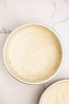 two bowls filled with batter sitting on top of a white counter