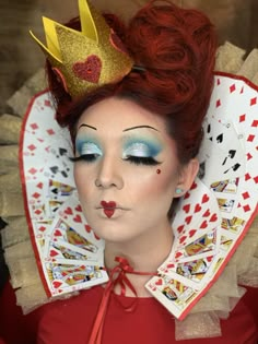 a close up of a person wearing a costume with playing cards on it's head