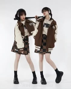 two young women are dressed in brown and white outfits with headphones on their ears