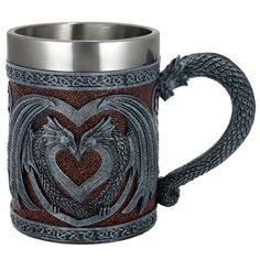 a dragon mug with a heart in the middle and two snakes on it's sides