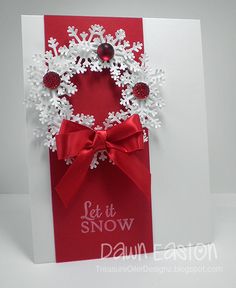 a red and white christmas card with snowflakes on it, featuring a wreath