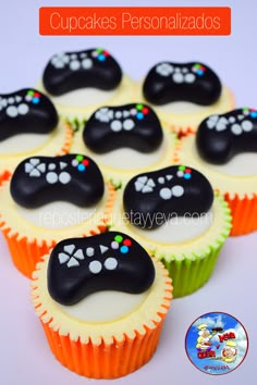 cupcakes with black and white frosting decorated like video game controller controllers on them