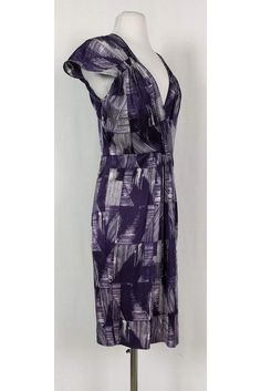 This pretty dress has a fun abstract print in a chic purple and white color. Cap sleeves, a plunging neckline and pleats along the waist all elevate this basic dress from Poleci. It can be dressed up or down for any occasion. Size 4 91% silk, 9% lycra V-neck Cap sleeves Side zipper Unlined Abstract print Bust 34.5" Waist 30" Shoulder to hem 39" Elegant V-neck Maxi Dress With Abstract Print, Fitted V-neck Midi Dress With Abstract Print, Fitted Purple Printed Midi Dress, Elegant V-neck Midi Dress With Abstract Print, Formal Printed V-neck Dress, Fitted V-neck Dress With Abstract Print, Elegant Maxi Dress With Abstract Print And V-neck, Purple V-neck Lined Dress, Printed V-neck Midi Dress For Evening