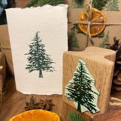 an orange and some pine trees on a table