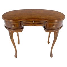 a wooden desk with two drawers on one side and an oval shaped drawer on the other