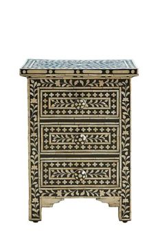 an intricately decorated wooden cabinet with two drawers on one side and a marble top