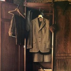 a suit and tie are hanging in a closet