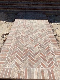 an old brick walkway is laying on the ground