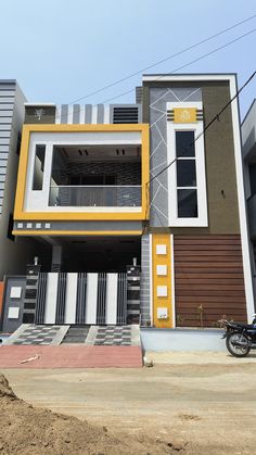 a motorcycle is parked in front of a multi - colored building with multiple balconies