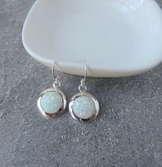 White opal earrings. The stones are set into .925 solid sterling silver. These are beautiful opal stones, with gorgeous blue/aqua  and orange/gold/green flecks. These earrings have really wonderful sparkle that is difficult to capture with a camera, but in person are just beautiful! Everytime you move, the stone flashes specks of color. The opal stones are lab created, made with silica the same way natural opals are formed. For size and details please see description below.  -------------------- White Opal Earrings, Opal Birthstone, Gemstone Properties, Birthstone Gifts, French Wire, Opal Stone, October Birthstone, Opal Earrings, Natural Opal