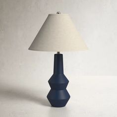 a blue table lamp with a white shade on it