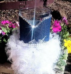 a blue and white cake sitting on top of a wooden table next to some flowers