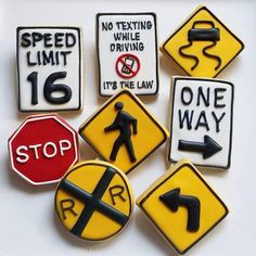 several different types of road signs on a white surface with one way and no texting, while the other says it's the law