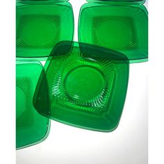 four green glass plates sitting on top of each other