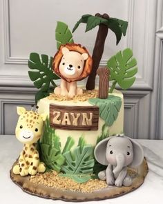 a cake decorated with animals and plants on a table