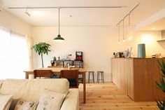 a living room filled with furniture next to a kitchen