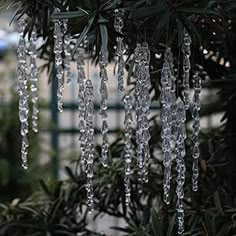 icicles hanging from the branches of a pine tree