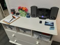 there is a desk with many items on it