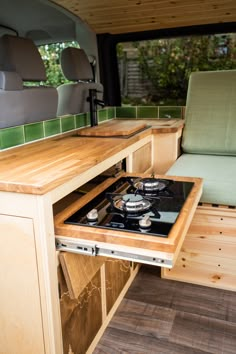 a stove top oven sitting inside of a camper