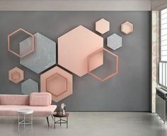 a living room filled with furniture next to a wall covered in hexagonal shapes