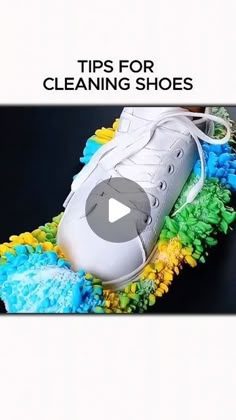 a pair of tennis shoes sitting on top of a cleaning brush