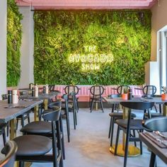 an indoor restaurant with plants on the wall