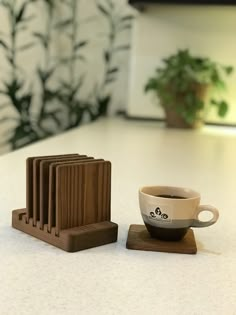 a cup of coffee sitting on top of a wooden coaster next to a stack of books