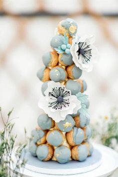 a blue and white cake with flowers on top