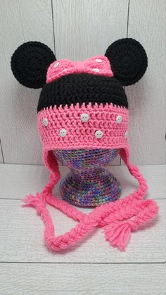 a crocheted minnie mouse hat on top of a mannequin head