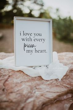 a sign that says i love you with every pizza in my heart on top of a rock