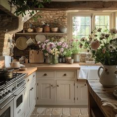 a kitchen filled with lots of pots and pans on top of a stove top oven